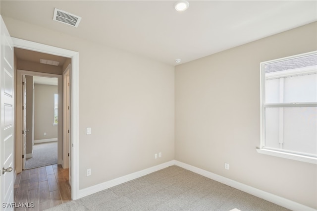 spare room with wood-type flooring