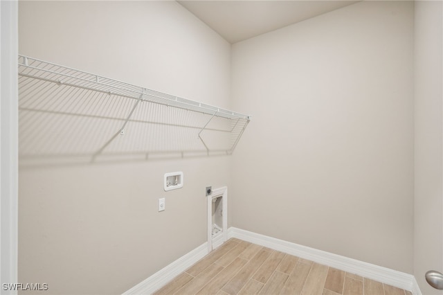 clothes washing area featuring hookup for a washing machine, hardwood / wood-style floors, and hookup for an electric dryer