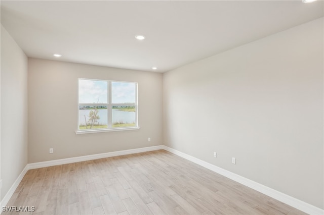 unfurnished room with light hardwood / wood-style floors