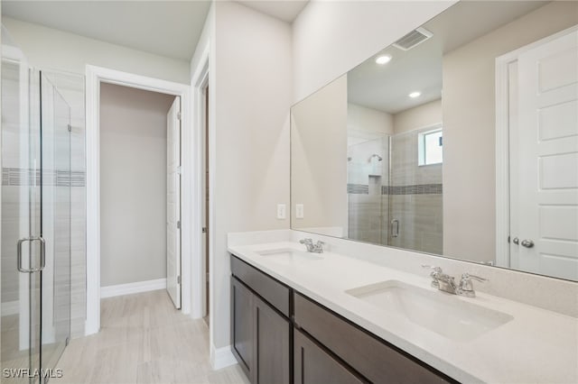 bathroom with vanity and a shower with shower door