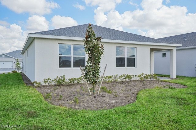 back of house with a lawn