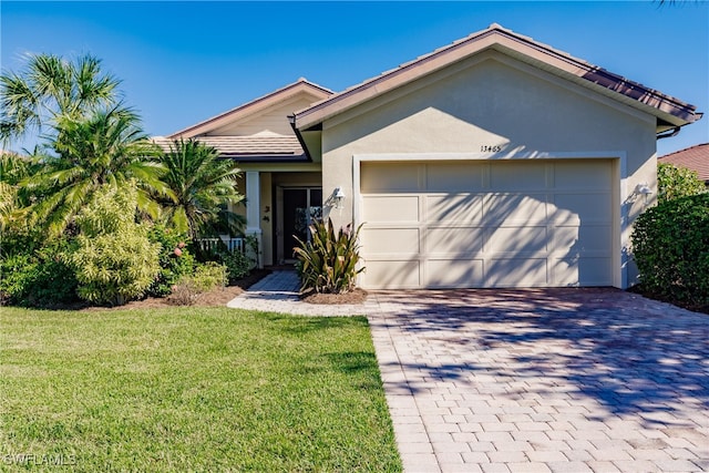 view of front of house with a front lawn and a garage