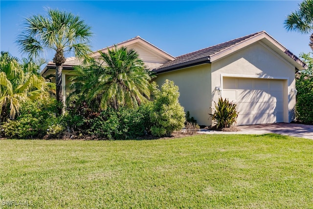 view of front of home with a front yard and a garage