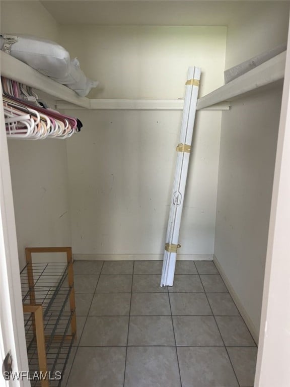 walk in closet featuring tile patterned flooring