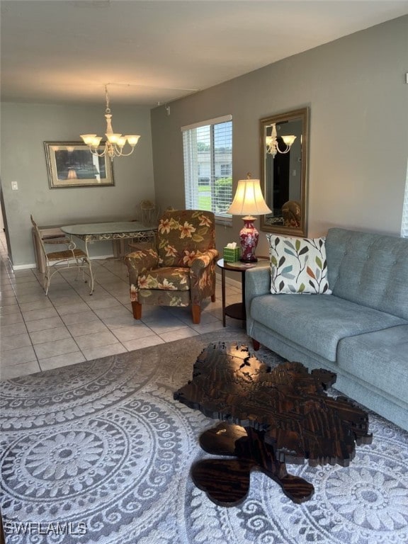 tiled living room with a notable chandelier