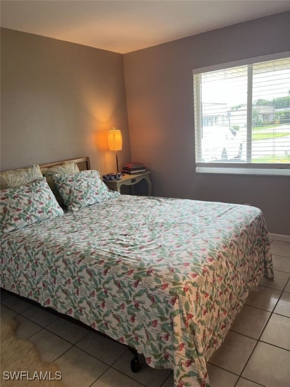 bedroom with light tile patterned floors