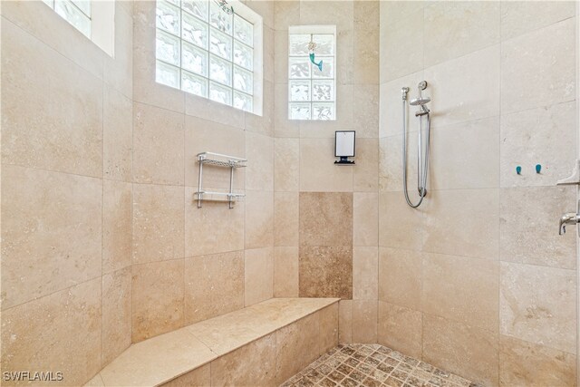 full bath featuring tiled shower