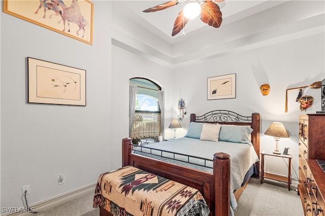 bedroom featuring baseboards, a ceiling fan, and light colored carpet