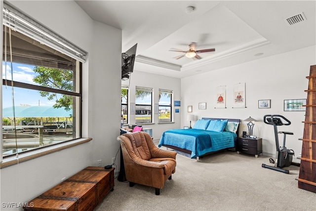 bedroom with ceiling fan, a mountain view, carpet floors, visible vents, and a raised ceiling