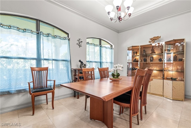 dining area with a chandelier, light tile patterned flooring, crown molding, and baseboards