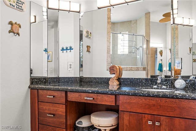 full bathroom featuring a stall shower and vanity