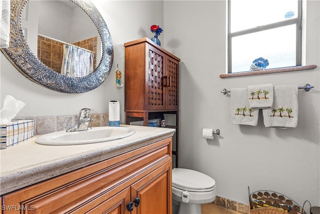 full bathroom featuring a shower with curtain, vanity, toilet, and tile patterned floors