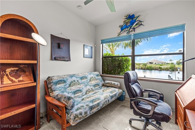 office area with ceiling fan, a water view, and carpet flooring