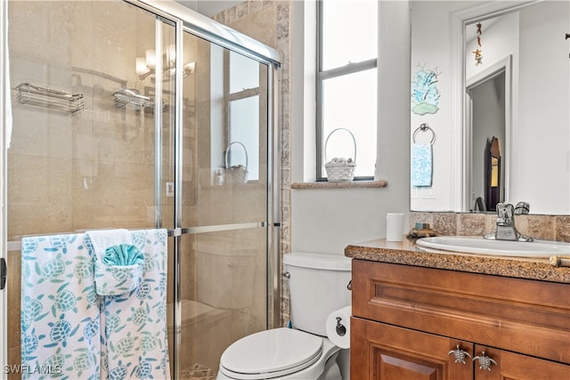 full bath with toilet, a shower stall, and vanity