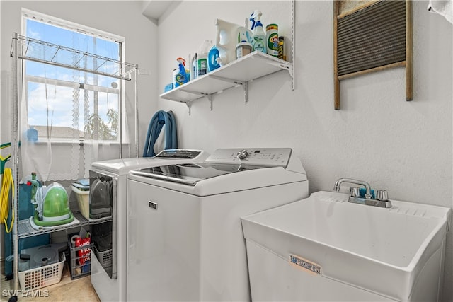 laundry room featuring independent washer and dryer, laundry area, and a sink