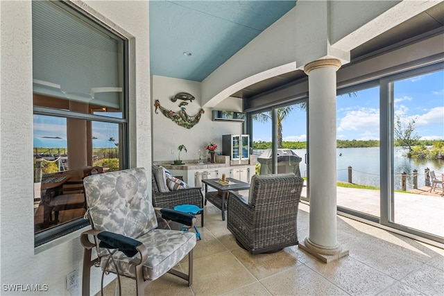 sunroom with a water view and ornate columns