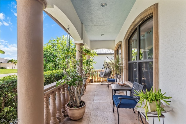 view of patio featuring a balcony