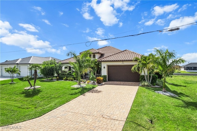 mediterranean / spanish house with a tile roof, an attached garage, decorative driveway, a front lawn, and stucco siding