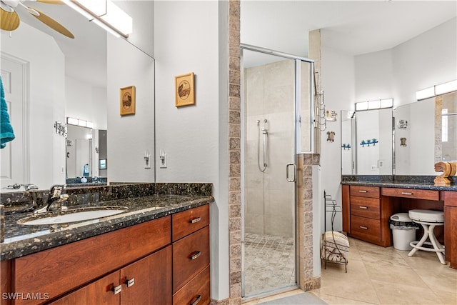 bathroom with tile patterned floors, a shower stall, vanity, and a ceiling fan