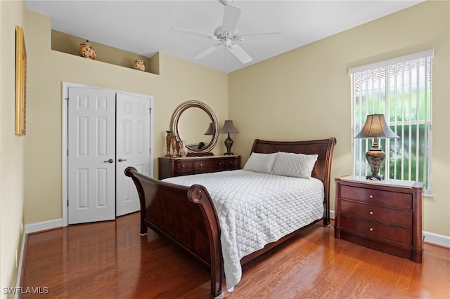 bedroom with hardwood / wood-style flooring, ceiling fan, and a closet