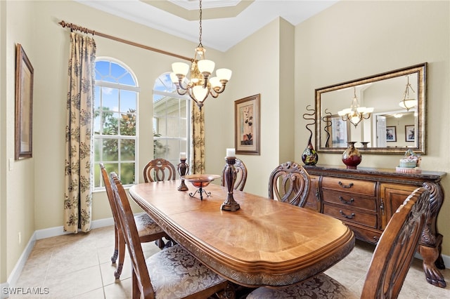 tiled dining area featuring an inviting chandelier