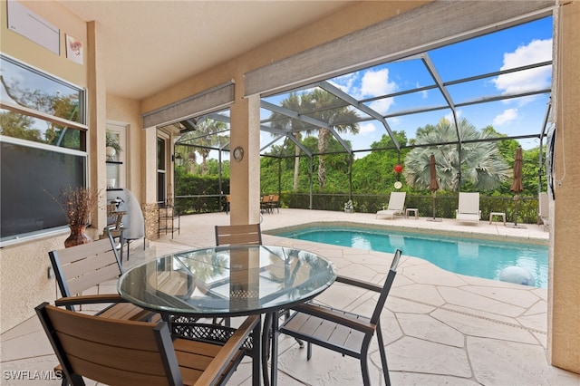 view of swimming pool featuring a lanai and a patio