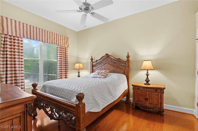 bedroom with hardwood / wood-style flooring and ceiling fan