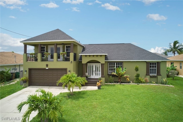 view of front of property with a garage and a front lawn