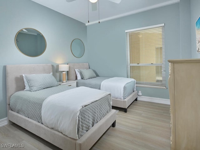 bedroom with light hardwood / wood-style floors and ceiling fan