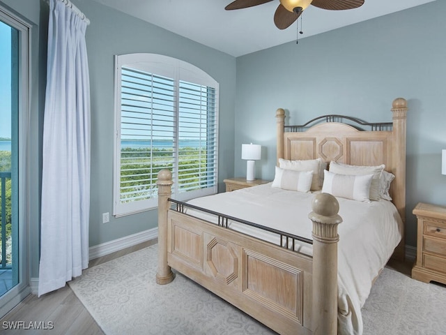 bedroom with light hardwood / wood-style floors and ceiling fan