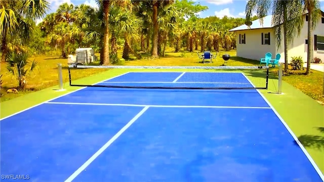 view of sport court with a lawn and basketball court