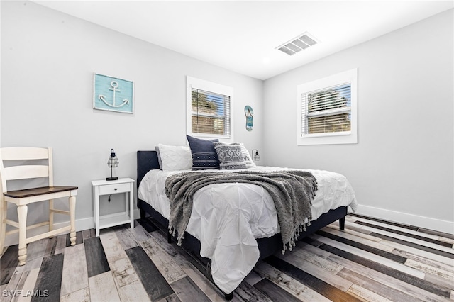 bedroom with hardwood / wood-style floors