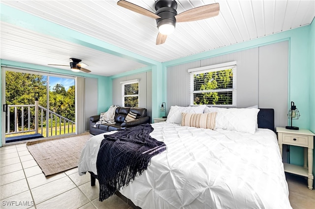 bedroom with light tile patterned floors, multiple windows, access to outside, and ceiling fan