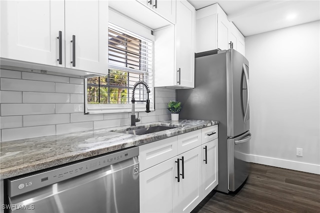 kitchen with sink, white cabinets, stainless steel appliances, dark hardwood / wood-style flooring, and light stone countertops