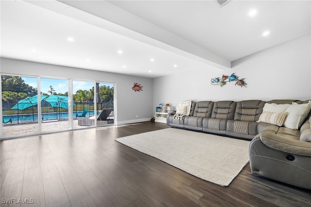 living room featuring beam ceiling and dark hardwood / wood-style flooring