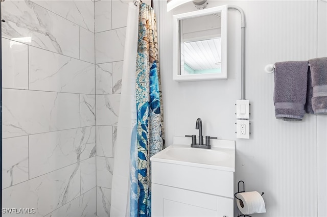 bathroom with walk in shower and vanity