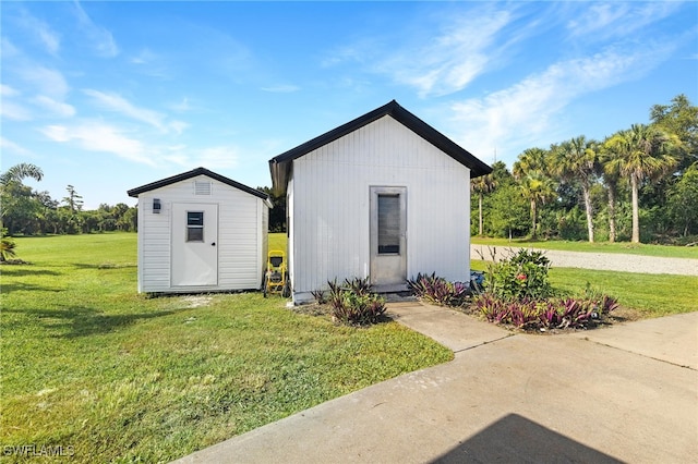 view of outbuilding with a yard