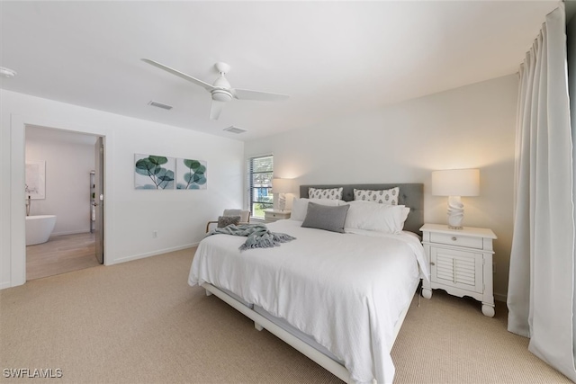 carpeted bedroom with connected bathroom and ceiling fan