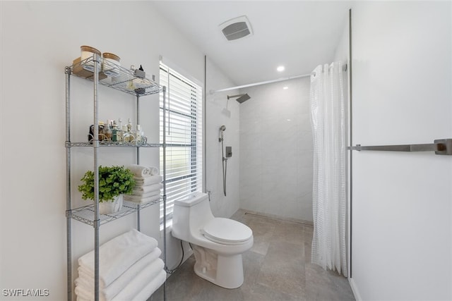 bathroom featuring toilet and a shower with shower curtain