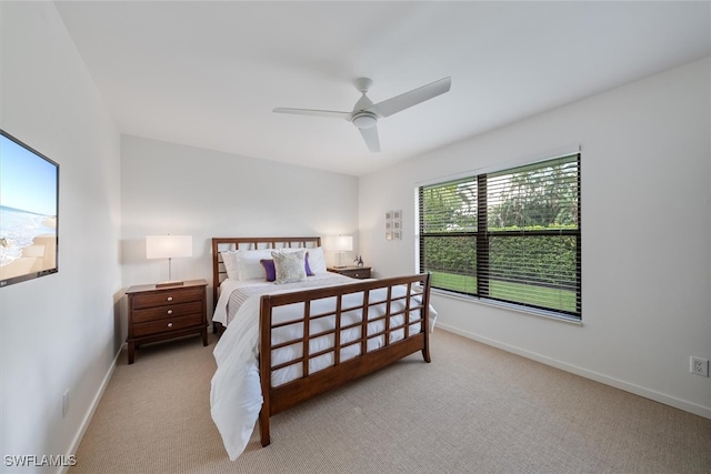 bedroom featuring ceiling fan and light carpet