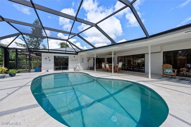 view of pool featuring a lanai, ceiling fan, and a patio area