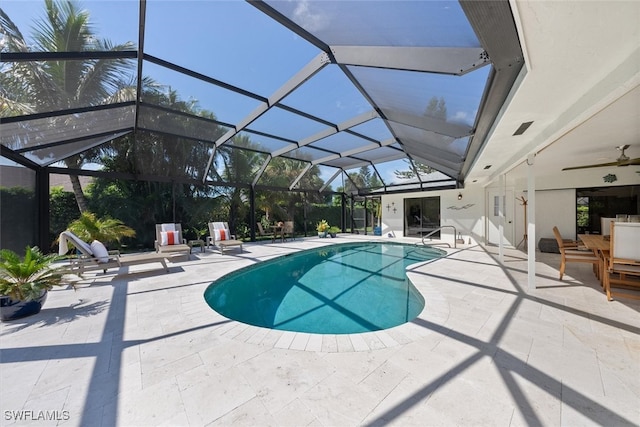 view of swimming pool with a patio, a lanai, and ceiling fan