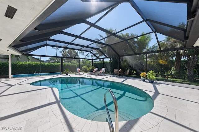 view of pool featuring a lanai and a patio