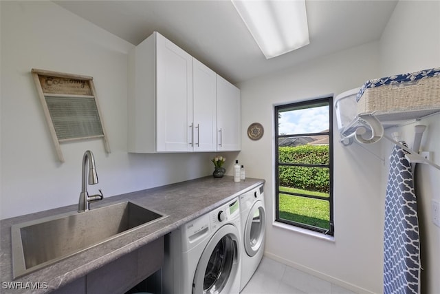 laundry area featuring light tile patterned floors, sink, independent washer and dryer, and cabinets