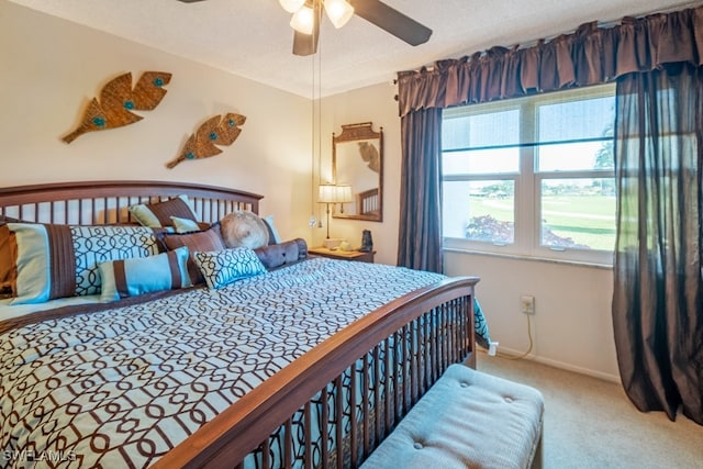 carpeted bedroom with ceiling fan, a textured ceiling, and multiple windows