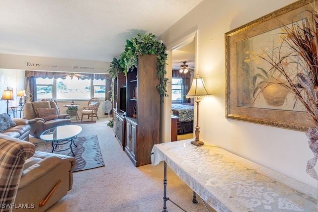 living room featuring ceiling fan and light carpet