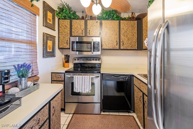 kitchen with ceiling fan, appliances with stainless steel finishes, and light tile patterned floors