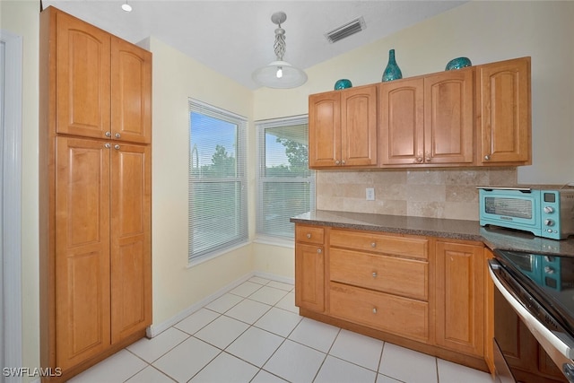 kitchen with backsplash, light tile patterned flooring, hanging light fixtures, and stainless steel range with electric stovetop