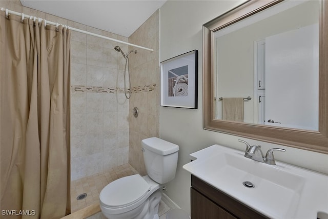 bathroom featuring vanity, toilet, and curtained shower