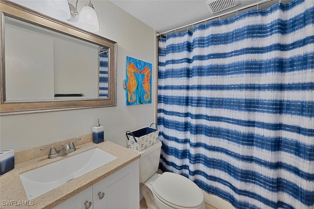 bathroom featuring a shower with curtain, vanity, and toilet